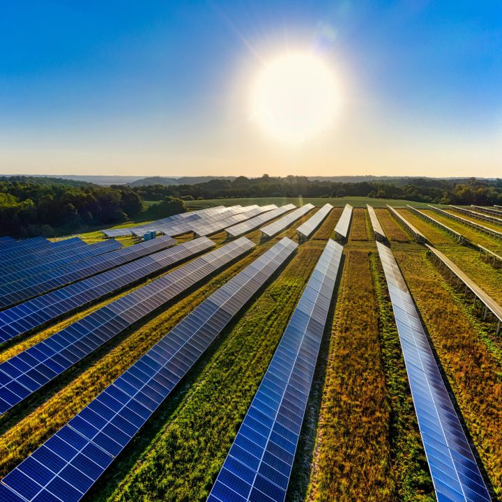 Aerial view of a solar farm in Red Wing, MN, with solar panels harnessing the sun's energy.